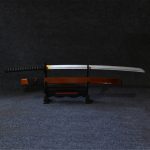Professional photo of the #1 Neon Marble Samurai Katana with a unique phosphorus green marble scabbard and 104cm silver wooden blade, displayed on a wooden stand in a modern gaming setup with dynamic RGB lighting.