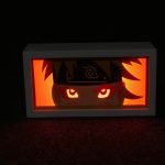 Professional studio photo of the Naruto Shippuden 3D Shadow Box with vibrant orange LED lighting and multi-layered depth.