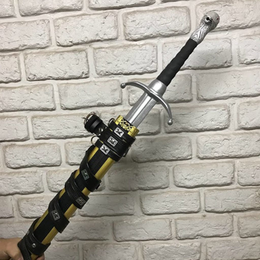 A 113cm wooden replica of Jon Snow’s Longclaw sword from Game of Thrones, featuring a hand-painted white wolf pommel and a premium gold-trimmed black scabbard with leather straps.