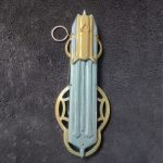 Handcrafted wooden Hidden Blade from Assassin’s Creed Mirage extended on a forearm.